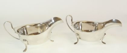 A PAIR OF VINERS SILVER SAUCE BOATS, with cyma edge and loop handles, raised on three pad feet,