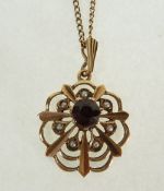 A 9CT GOLD RED STONE AND SEED PEARL OPENWORK PENDANT, London 1969, on 9ct gold fine chain