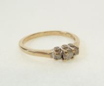A 9CT GOLD DIAMOND RING, set with three graduated diamonds, centre diamond 0.12ct approx., and the