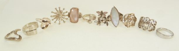 A SILVER RING SET WITH A RECTANGULAR CHECKERBOARD CUT ROSE QUARTZ, THREE SILVER RINGS SET WITH