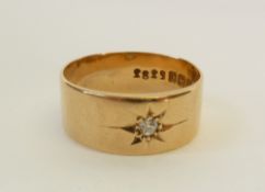 AN 18CT GOLD DIAMOND SET WEDDING RING, star set with a round brilliant cut diamond, 0.05ct