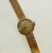 LADY`S ROAMER, 9CT GOLD CASED WRIST WATCH, small gilt dial with batons, ON INTEGRAL 9CT GOLD