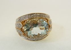 A STAMPED 14K GOLD, AQUAMARINE AND DIAMOND RING, with a horizontally set oval mixed cut