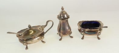A THREE PIECE SILVER CONDIMENT SET, bombe shape with cyma edges, raised on four scroll feet, with