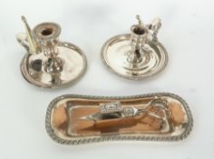 A TWO SILVER ON COPPER CHAMBERSTICKS, EACH WITH CONICAL SNUFFER, A WAISTED OBLONG TRAY AND A PAIR OF