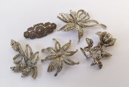 A SELECTION OF FIVE SILVER METAL AND MARCASITE BOW AND FLORAL BROOCHES