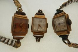 THREE LADY`S STAMPED 18CT GOLD CASED WRIST WATCHES, mechanical movements, each with square