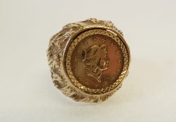 A 9CT GOLD BROAD TEXTURED SIGNET RING, SET WITH A 1 TALLAR 1853 COIN, 7.4g