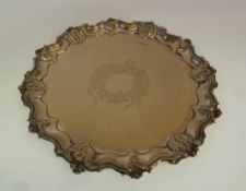 A LATER VICTORIAN SILVER SALVER, the centre engraved with a vacant cartouche within a raised pie-