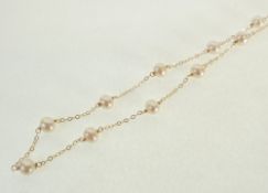 A STAMPED 14CT GOLD AND CULTURED PEARL NECKLACE, the fine chain necklace with nineteen off-round