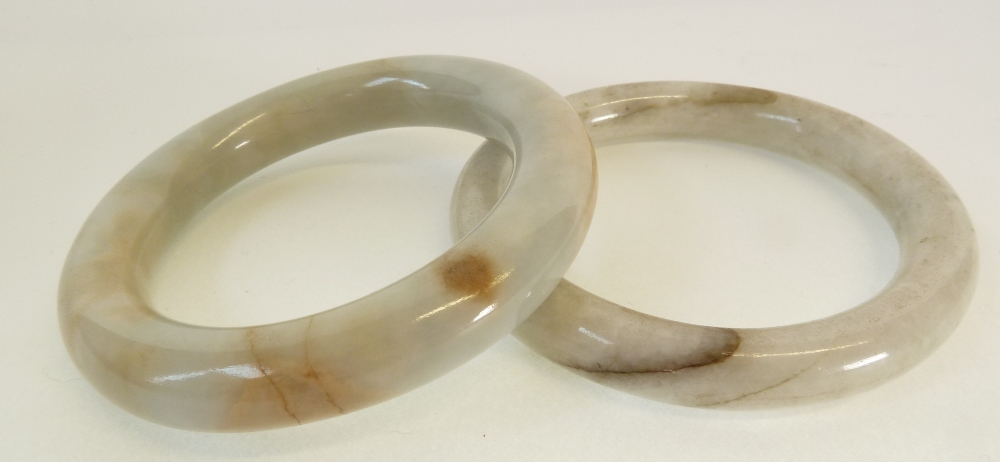 A PAIR OF PALE GREEN HARDSTONE BANGLES