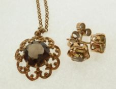 A 9CT GOLD SMOKEY QUARTZ SET OPENWORK PENDANT ON CHAIN AND A PAIR OF CITRINE SET 9CT GOLD