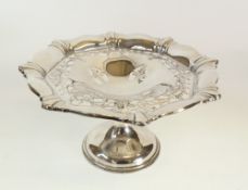 A GEORGE V SILVER PEDESTAL CAKE STAND, with cyma edge and cut-card pierced foliate centre and