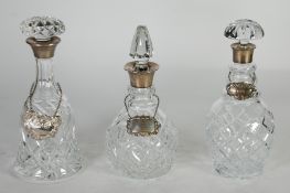 ASPREY OF LONDON. CUT GLASS DECANTER with silver collar and spire shaped stopper, Birmingham 1914,