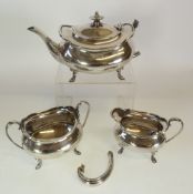 A GEORGE V SILVER BACHELOR THREE PIECE TEA SERVICE, BY ATKIN BROTHERS, bombe shaped with