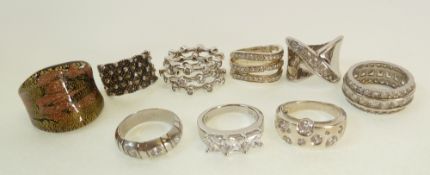 EIGHT SILVER AND CUBIC ZIRCONIA AND PASTE SET RINGS, AND A BLACK ART GLASS RING (9)