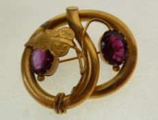 A VICTORIAN GILT METAL LARGE OPEN WORK PASTE SET BROOCH, knot form with gilt leaf and two claw and