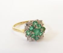 AN 18CT GOLD EMERALD AND DIAMOND CLUSTER RING, claw set with six round emeralds in two tiers, and