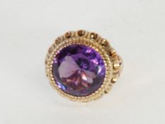 14K GOLD RING set with a large circular COLOUR CHANGE SAPPHIRE, 9.5gms