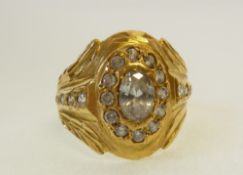 A GOLD AND WHITE STONE GENT`S RING, the broad oval top set with an oval white stone with twelve