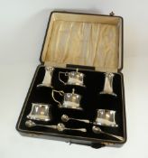 A CASED SIX PIECE SILVER CASED AND BLACK BAKELITE LINED CONDIMENT SET, comprising two pepperettes,