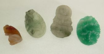 TWO CARVED GREEN HARDSTONE PENDANTS, one carved with a cockrel, the other a deity, A CARVED AGATE