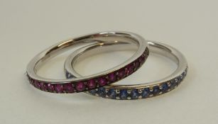 SET OF TWO MAPPIN & WEBB, 18CT WHITE GOLD GEM SET HALF HOOP RINGS, one claw set with 18 sapphires,