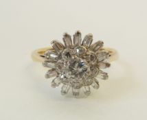 A STAMPED 18CT GOLD AND PLATINUM DIAMOND THREE TIER CLUSTER RING, the central claw set brilliant cut