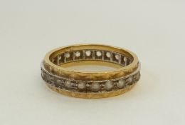 AN 18CT GOLD WHITE STONE SET ETERNITY RING, with textured gold shank with milligrain stone set