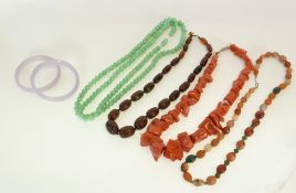 A HORN BEAD NECKLACE, A ROUGH DYED GREEN CORAL BEAD NECKLACE, TWO GREEN BEAD NECKLACES, A PAIR OF