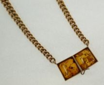 A VICTORIAN 15CT GOLD GRADUATED ALBERT, with two later amber set clips to form a necklet, 53.7g