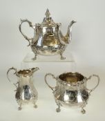 A VICTORIAN SILVER THREE PIECE TEA SERVICE BY WILLIAM HUNTER, baluster form, with embossed scroll