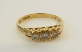 AN 18CT GOLD THREE STONE DIAMOND RING, the lozenge shaped top set with three graduated brilliant cut