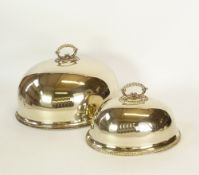 SIX MATCHED GRADUATED OVAL MEAT DOMES, with beaded edges and scroll handles, ranging from 15 ½" (