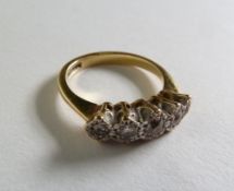 AN 18CT GOLD RING, WITH FIVE GRADUATED ILLUSION SET DIAMONDS, 3.5g