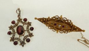 A 15CT GOLD DIAMOND AND RUBY LOZENGE SHAPED BROOCH, set with three graduated eight-cut melee