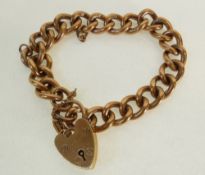 A 9CT GOLD CURB PATTERN LINK BRACELET, WITH 9CT GOLD PADLOCK CLASP, Birmingham 1991, 48.6g