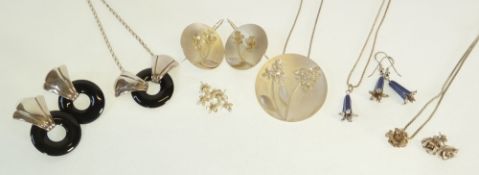 FOUR SILVER NECKLACE AND EARRING SETS, including, A SILVER DISK PENDANT, WITH APPLIED FLOWERS,