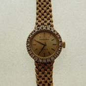 9ct GOLD BUECHE-GIROD LADY`S WRIST WATCH, with tiny diamond set bezel and integral braided link