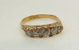 AN 18CT GOLD FIVE STONE OLD CUT DIAMOND RING, the lozenge shaped scroll gallery claw set with five