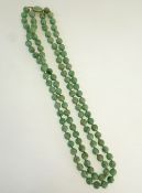 A DOUBLE STRAND NECKLACE OF 105 UNIFORM JADE BEADS, each 9.3mm diameter approx., WITH JADE