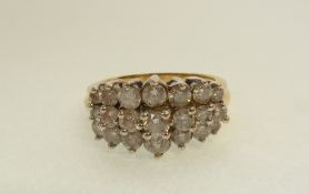 AN 18CT GOLD 21 STONE DIAMOND SET RING, the graduated round brilliant cut stones claw and collet set