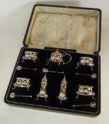 EARLY TWENTIETH CENTURY CASED SILVER CONDIMENT SET COMPRISING A MUSTARD POT with blue glass liner,