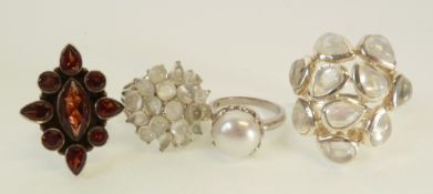 TWO SILVER MOONSTONE SET CLUSTER RINGS, A SILVER RING SET WITH GARNETS AND A SILVER RING SET WITH