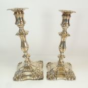 A PAIR OF EDWARDIAN BARKER BROTHERS WEIGHTED SILVER CANDLESTICKS, with shell capped corners, 9 ¾" (