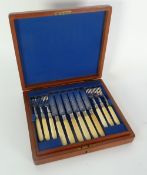 A LATE VICTORIAN MAHOGANY CASED SET OF TWELEVE ELECTROPLATED DESSERT KNIVES AND FORKS, with