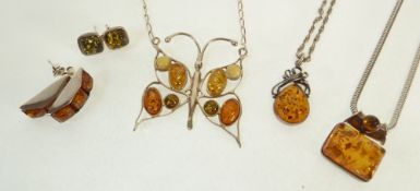 THREE SILVER SET AMBER PENDANT NECKLACES, ON SILVER CHAINS, AND TWO PAIRS OF SILVER SET AMBER