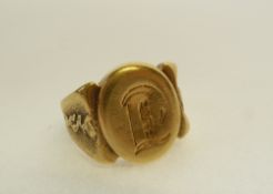 GENT`S GOLD SIGNET RING, monogramed oval shaped top with broad tapering embossed shoulders, 10.4g