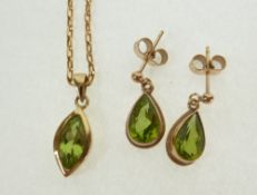 A PEAR CUT PERIDOT SET 9CT GOLD PENDANT ON CHAIN AND A NEAR MATCHED PAIR OF PERIDOT SET EARRINGS 5.