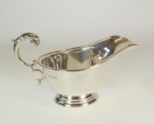 *A SILVER OVAL SAUCE BOAT WITH ACANTHUS FREE SCROLL HANDLE, on stepped oval foot, 6" long,